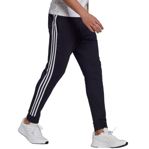 Spodnie adidas Essentials Fleece Tapered Cuff 3-Band M GK8823 Spodnie adidas Essentials Fleece Tapered Cuff 3-Band M GK8823
