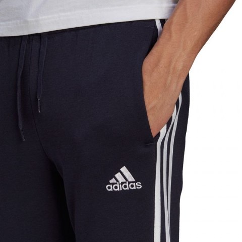 Spodnie adidas Essentials Fleece Tapered Cuff 3-Band M GK8823 Spodnie adidas Essentials Fleece Tapered Cuff 3-Band M GK8823