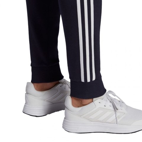 Spodnie adidas Essentials Fleece Tapered Cuff 3-Band M GK8823 Spodnie adidas Essentials Fleece Tapered Cuff 3-Band M GK8823